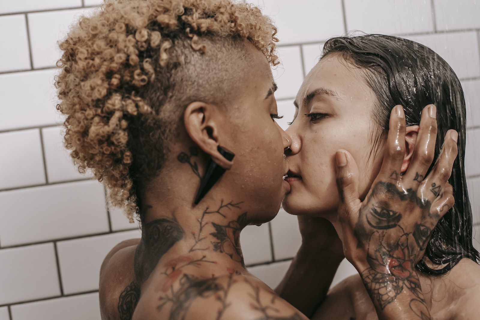 Passionate diverse couple taking shower together