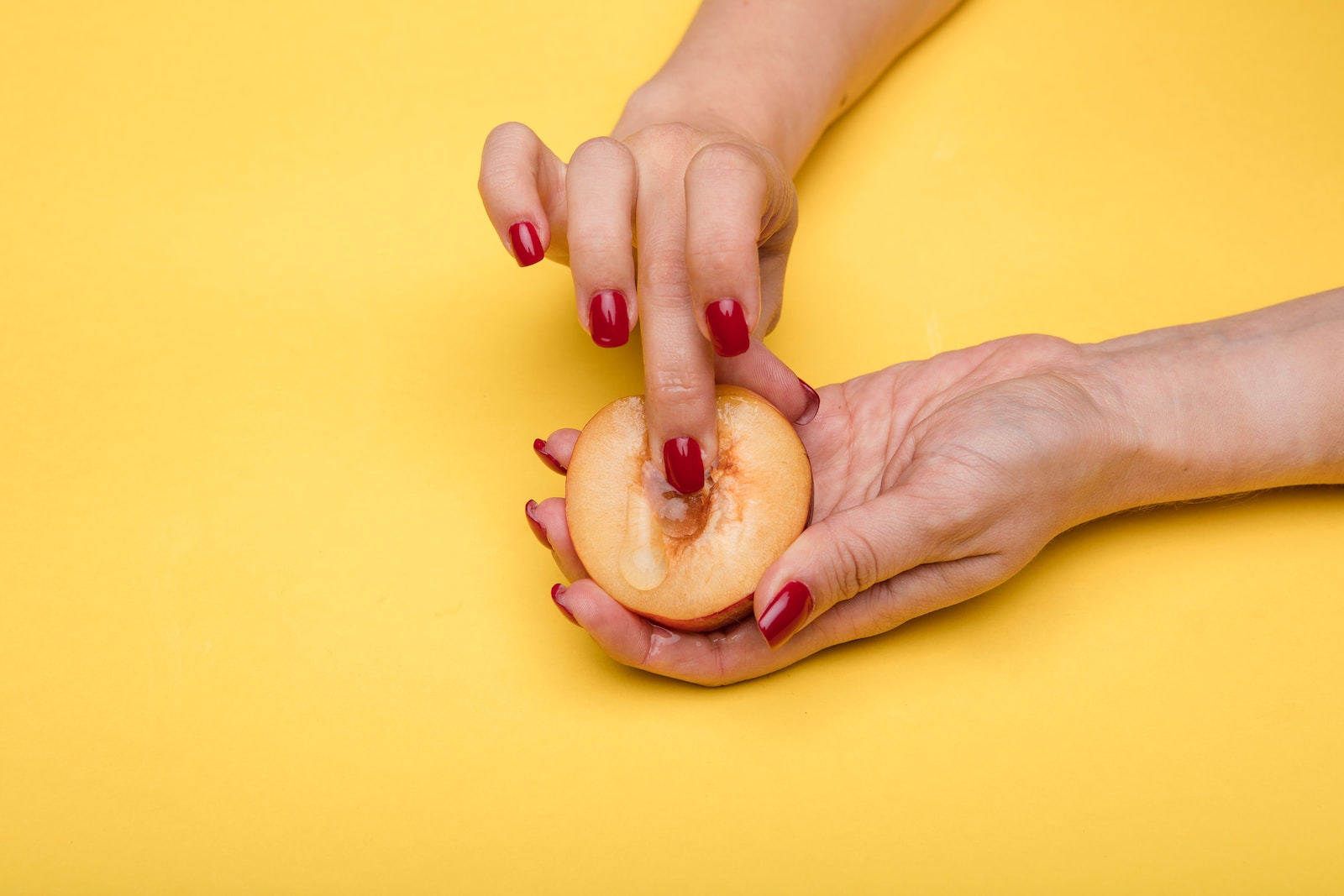 person holding sliced apple fruit